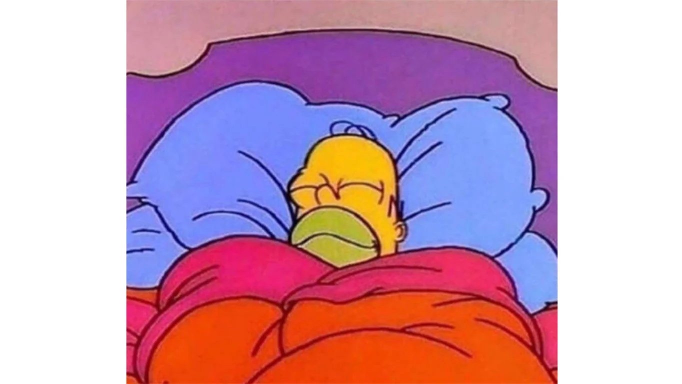 Una imagen caricaturesca de Homero Simpson dormido en la cama bajo una manta.